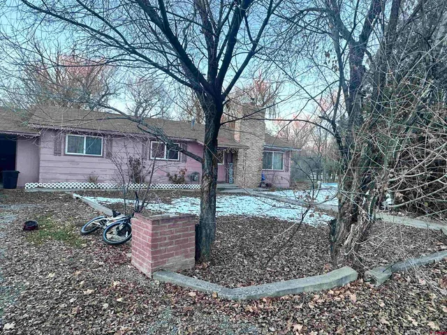 a backyard of a house with barbeque oven
