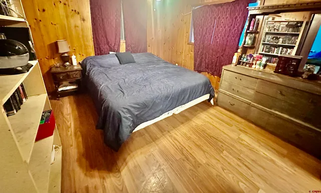 a bed sitting in a bedroom next to a window