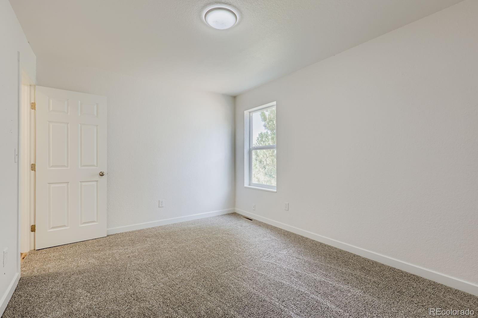 831 Sable Boulevard Aurora, CO 80011 - Photo 17 of 26 an empty room with windows