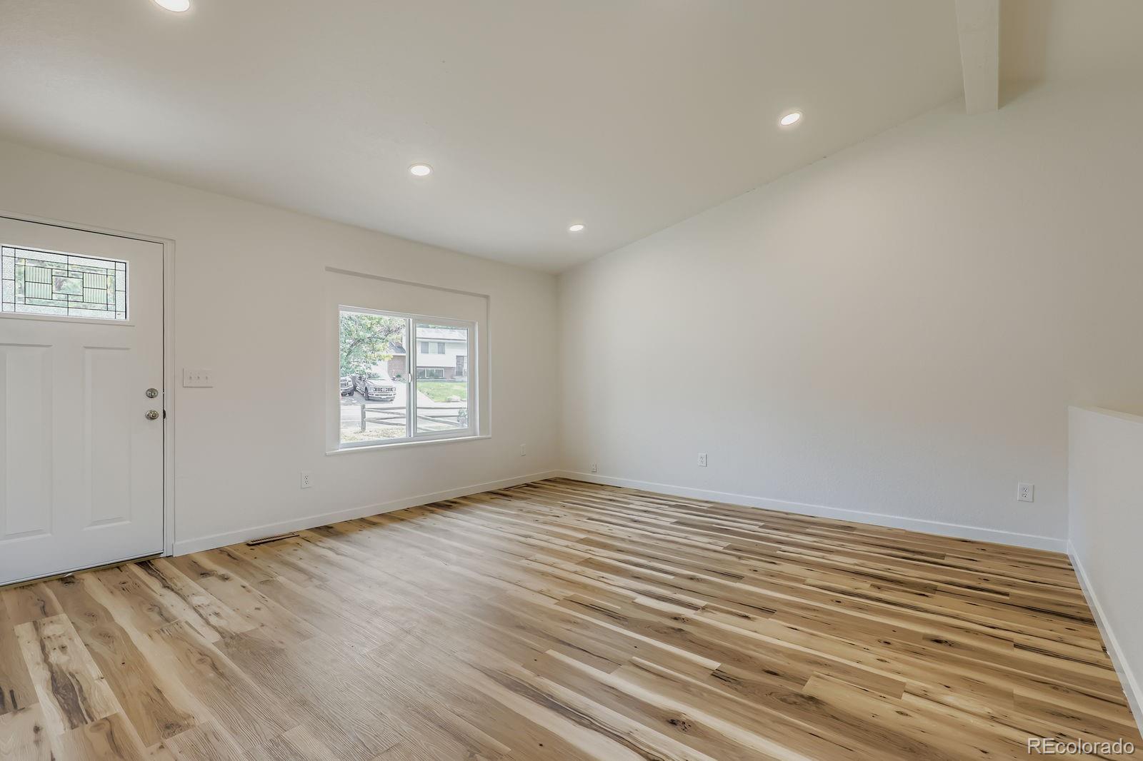 831 Sable Boulevard Aurora, CO 80011 - Photo 5 of 26 a view of an empty room and window