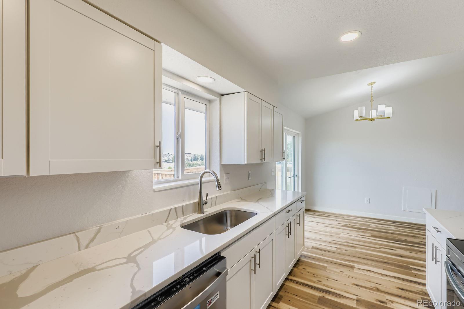 831 Sable Boulevard Aurora, CO 80011 - Photo 10 of 26 a kitchen with a sink and cabinets