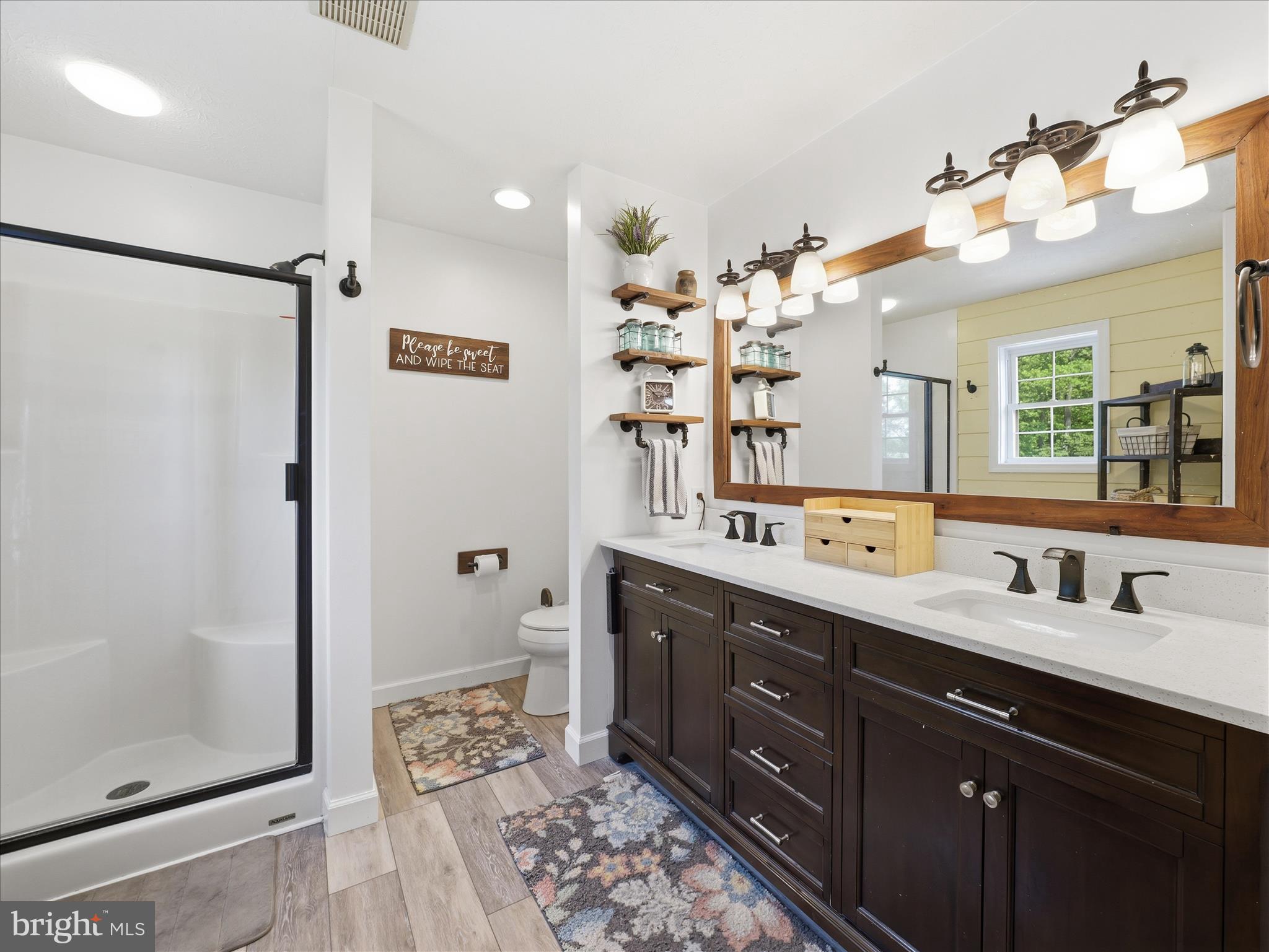 726 Doe Run Road Inwood, WV 25428 - Photo 48 of 68 a spacious bathroom with a double vanity sink mirror and shower