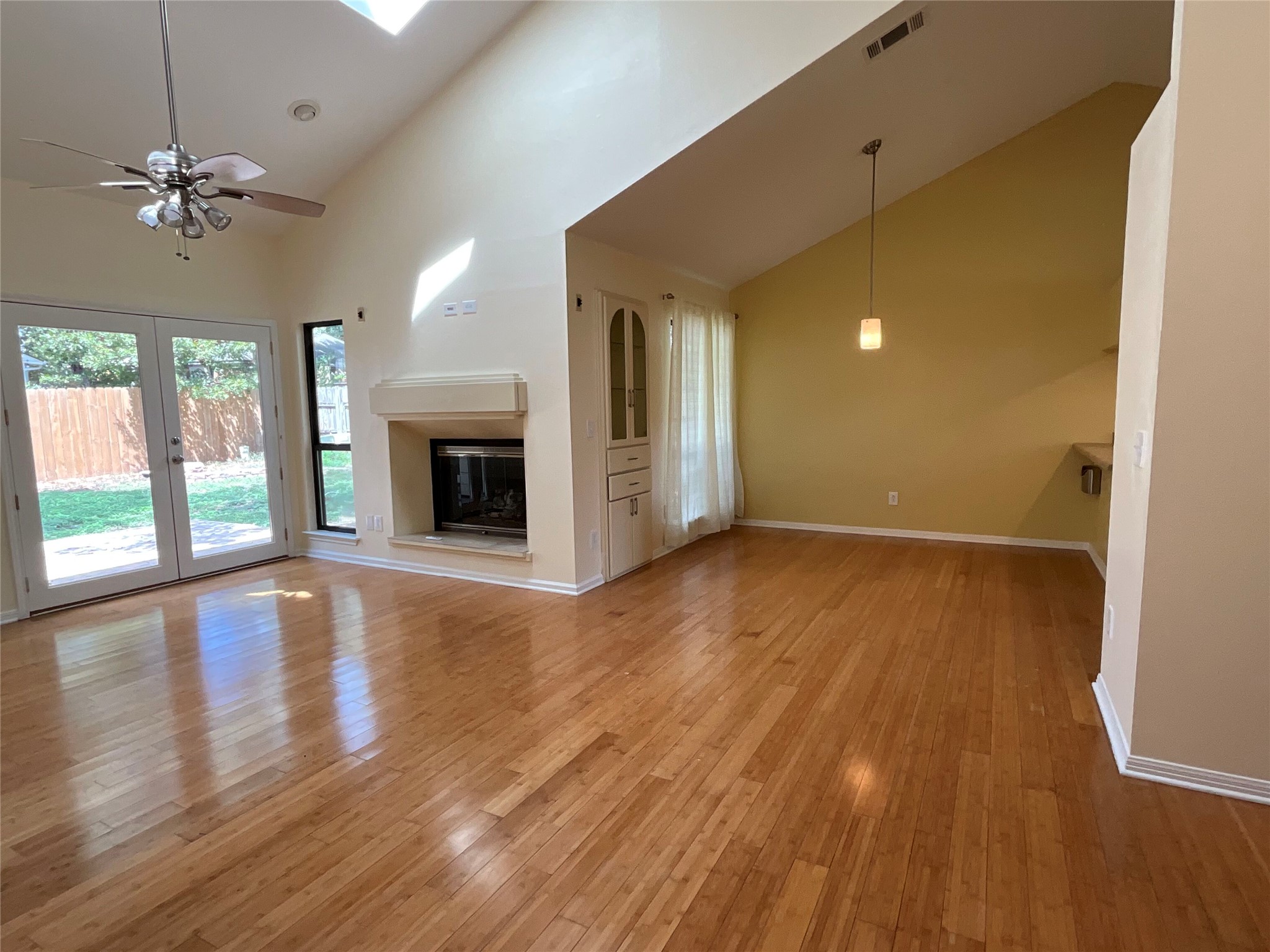 15702 Racine Cove Austin, TX 78717 - Photo 3 of 27 Hardwood floors and soaring vaulted ceilings create a spacious and inviting atmosphere in this open living area.