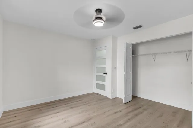 a bedroom with a large bed and a painting on the wall