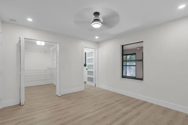 a bathroom with a granite countertop sink a toilet a mirror and shower