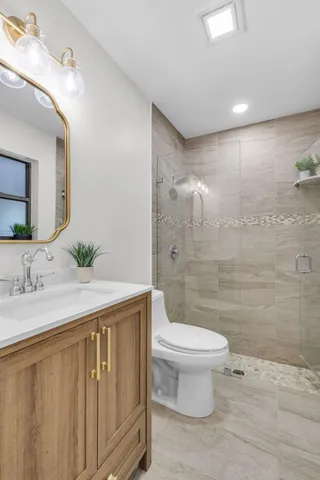 a bathroom with a double vanity sink mirror and toilet