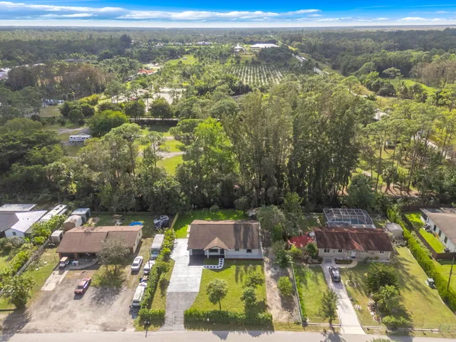an aerial view of a house with a garden and swimming pool