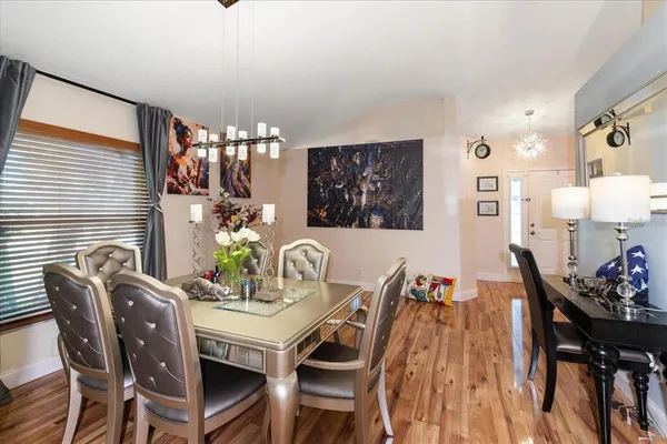 a view of a dining room with furniture and chandelier