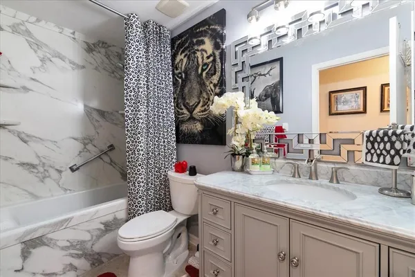 a bathroom with a sink vanity mirror and toilet