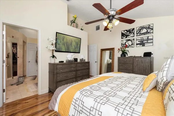 a bedroom with a bed and a flat screen tv