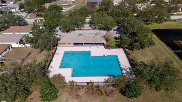 an aerial view of a house with yard swimming pool and outdoor seating