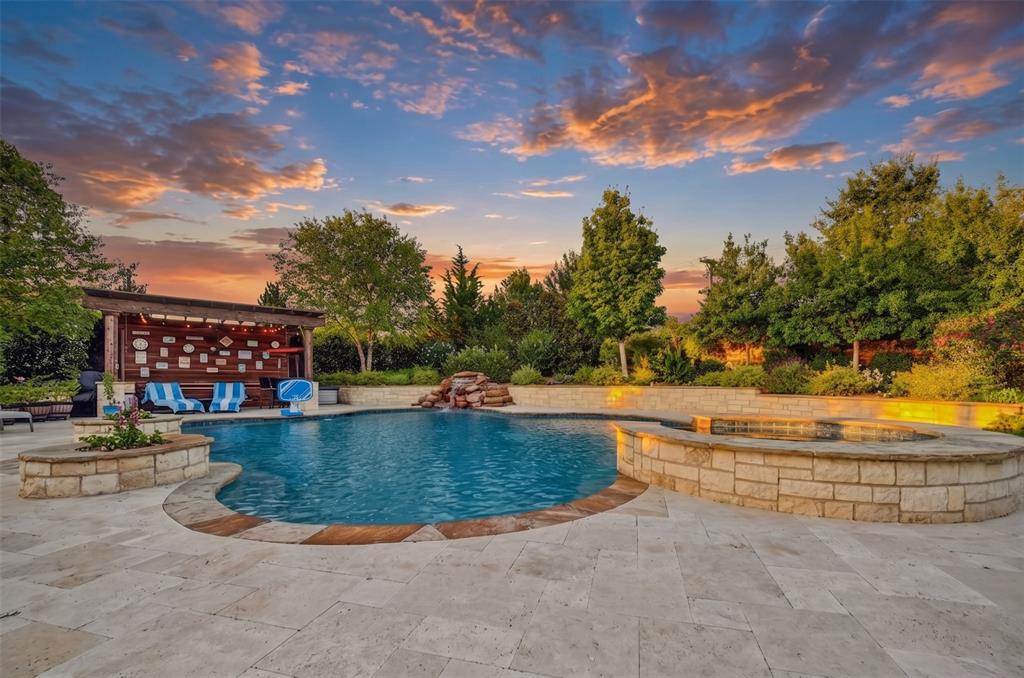 6656 Roughleaf Ridge Road Flower Mound, TX 76226 - Photo 1 of 40 a view of a swimming pool with an outdoor seating and a garden