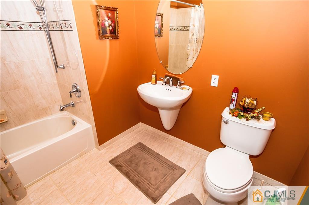 203 Potts Road Morganville, NJ 07751 - Photo 4 of 25 a bathroom with a sink toilet and shower