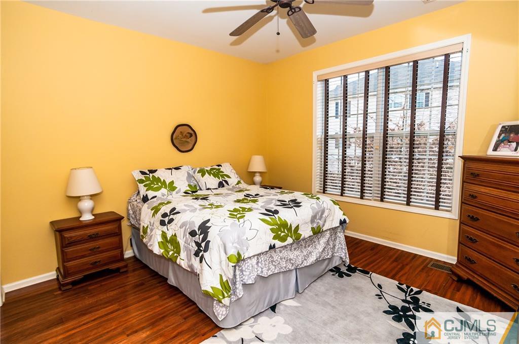 203 Potts Road Morganville, NJ 07751 - Photo 5 of 25 a bedroom with a bed and wooden floor
