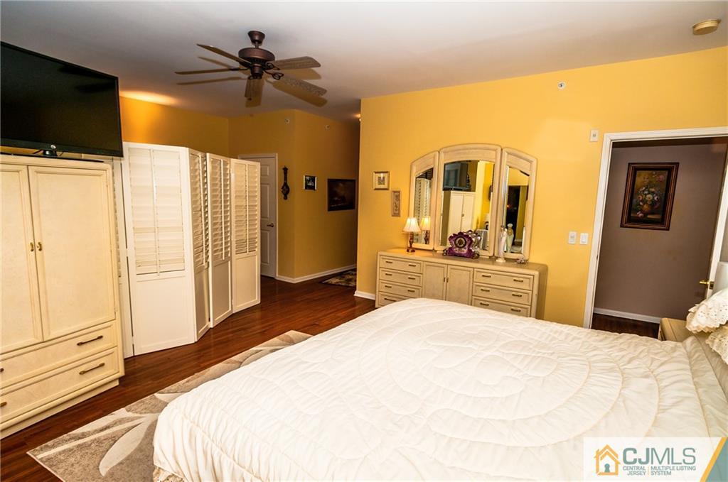 203 Potts Road Morganville, NJ 07751 - Photo 7 of 25 a bedroom with a bed and a flat tv screen on dresser