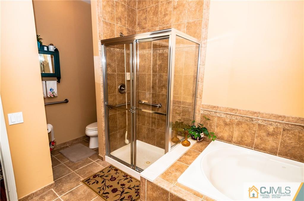203 Potts Road Morganville, NJ 07751 - Photo 8 of 25 a bathroom with a tub and shower