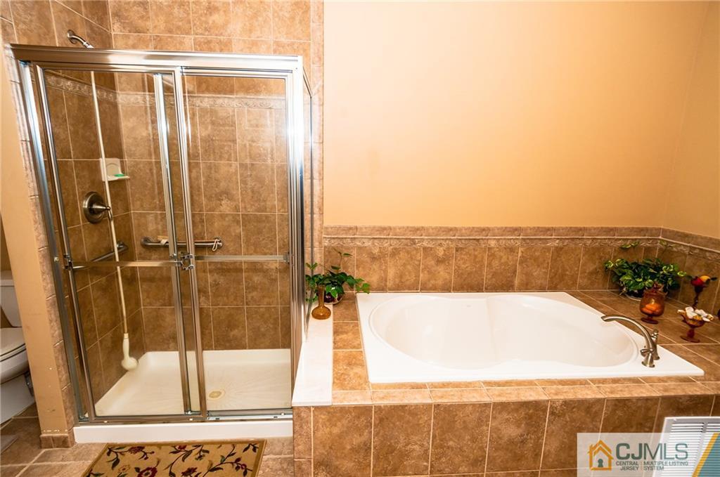 203 Potts Road Morganville, NJ 07751 - Photo 10 of 25 a view of a bathroom with a tub