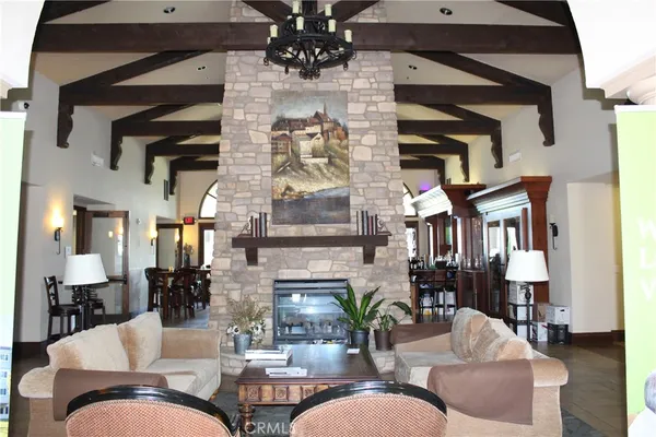 a living room with furniture a chandelier and a fireplace