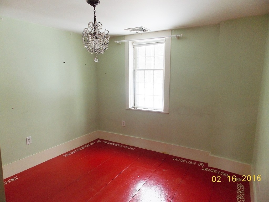 7 Wilder Lane Sterling, MA 01564 - Photo 10 of 21 an empty room with windows and chandelier