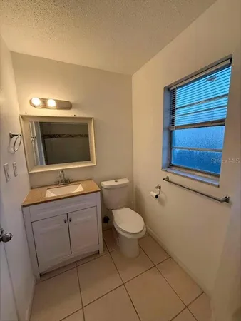 a kitchen with granite countertop a refrigerator and a sink