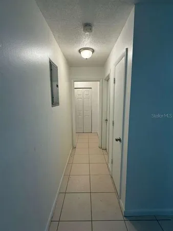 an empty room with white walls and tiles