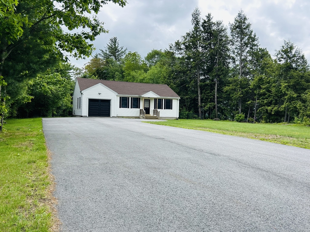 32 Sandy Pine Road Templeton, MA 01468 - Photo 2 of 30 a front view of a house with a yard and trees