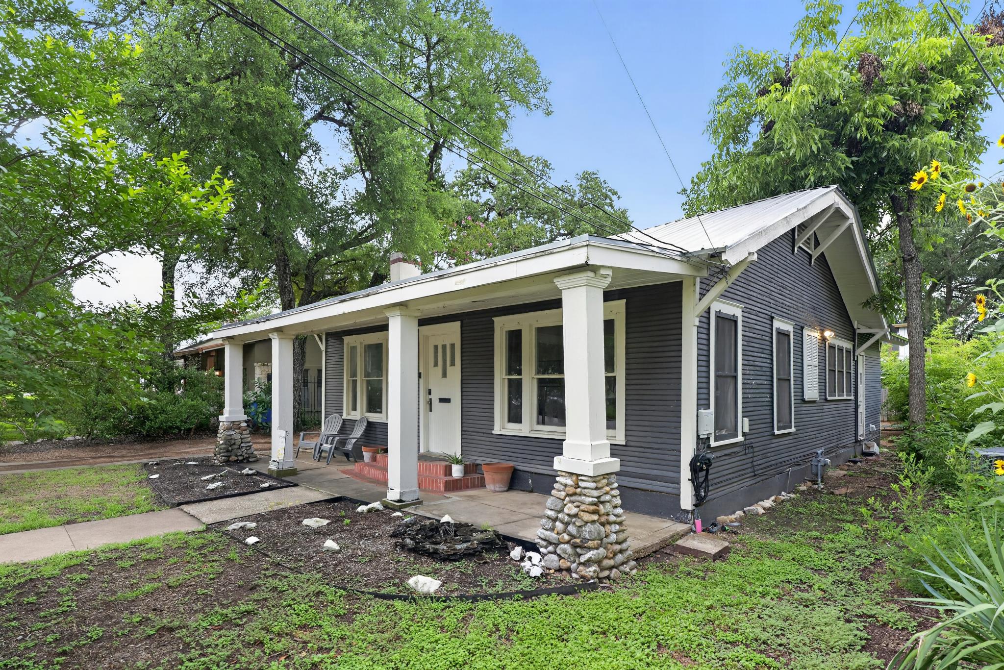307 East 35th Street, Unit A Austin, TX 78705 - Photo 5 of 40 A charming exterior with a wide front porch and mature trees creating a welcoming entry.