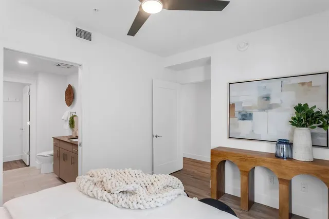 a spacious bathroom with a granite countertop sink and a mirror