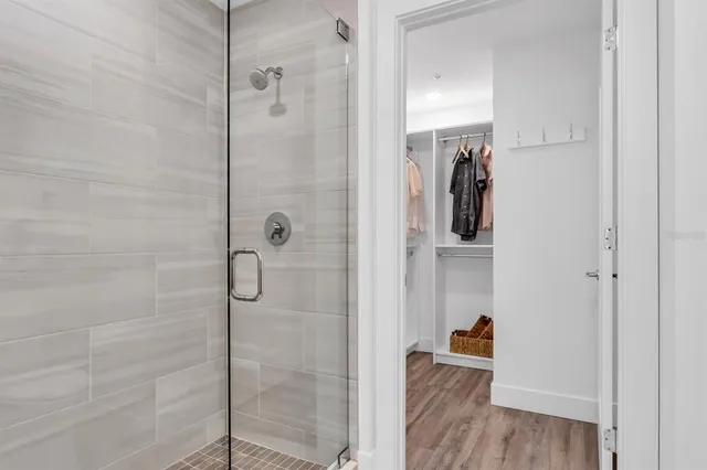 a view of walk in closet with clothes and shoes