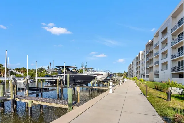 a view of a ocean with boats and trees in the background