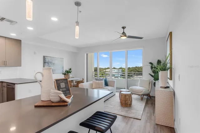 a kitchen with kitchen island granite countertop stainless steel appliances and wooden cabinets