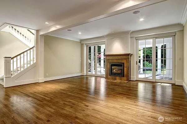 a view of a kitchen with a sink a fireplace and wooden floor