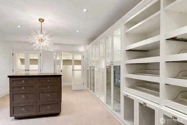 a spacious bathroom with a granite countertop sink a mirror and a shower