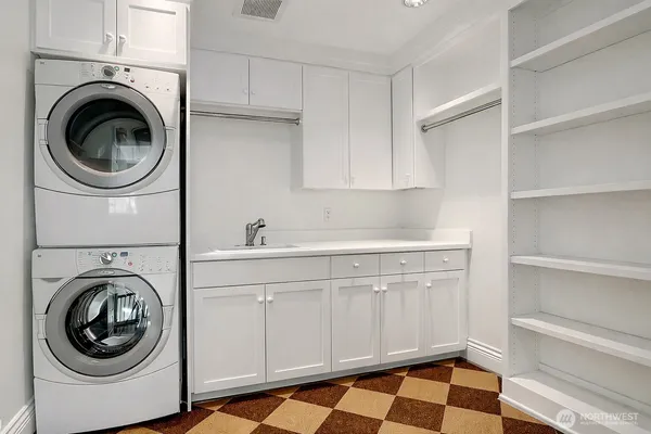a utility room with sink dryer and washer