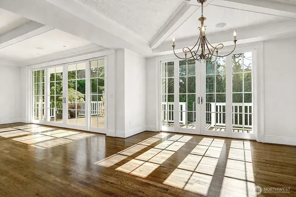 a view of a livingroom with wooden floor and a chandelier