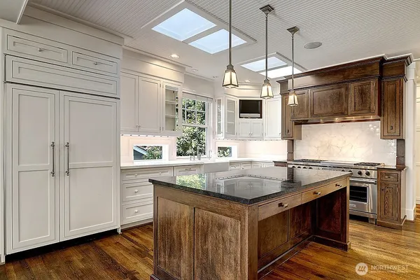 a kitchen with stainless steel appliances granite countertop a stove and a microwave