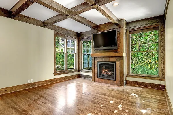 a view of an empty room with fireplace and a window