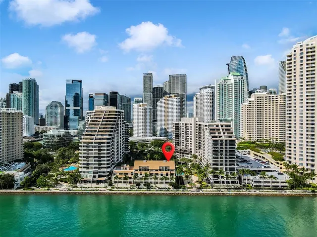 a view of a city with tall buildings and trees in the background