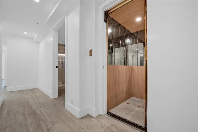 a view of a hallway with wooden floor