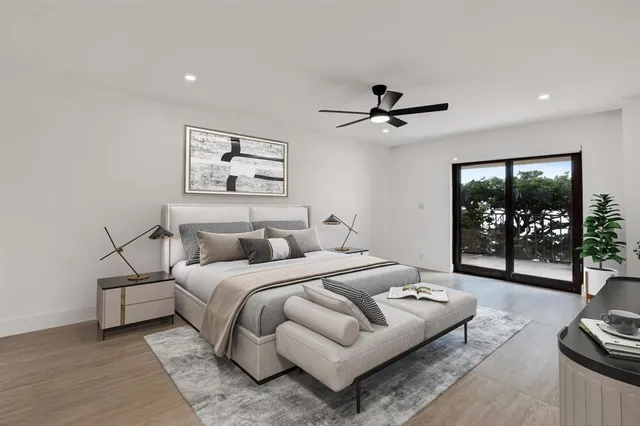 a bedroom with bed couches and a dining table with wooden floor