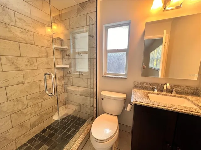 a bathroom with a toilet and a shower