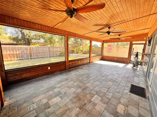 a view of a yard with wooden fence