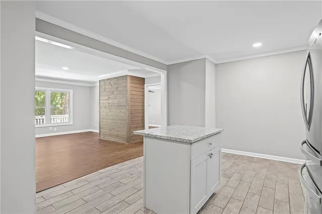a view of a kitchen with a sink and dishwasher with wooden floor