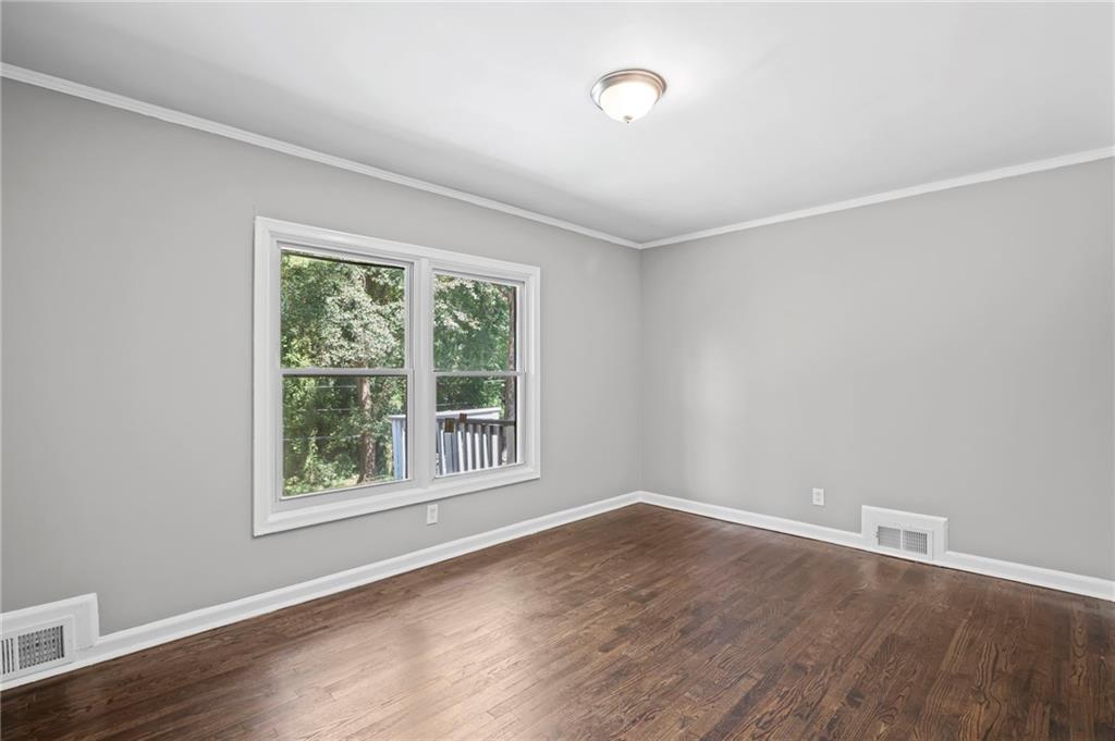 2790 Collier Drive Northwest Atlanta, GA 30318 - Photo 21 of 44 an empty room with wooden floor and windows