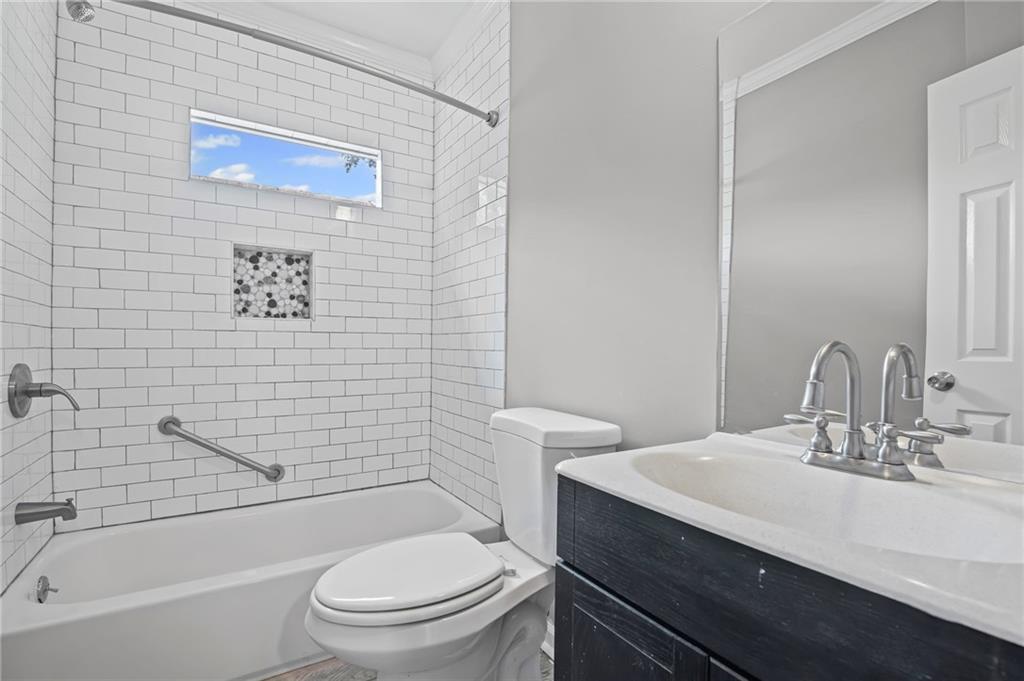 2790 Collier Drive Northwest Atlanta, GA 30318 - Photo 25 of 44 a bathroom with a sink a toilet and shower