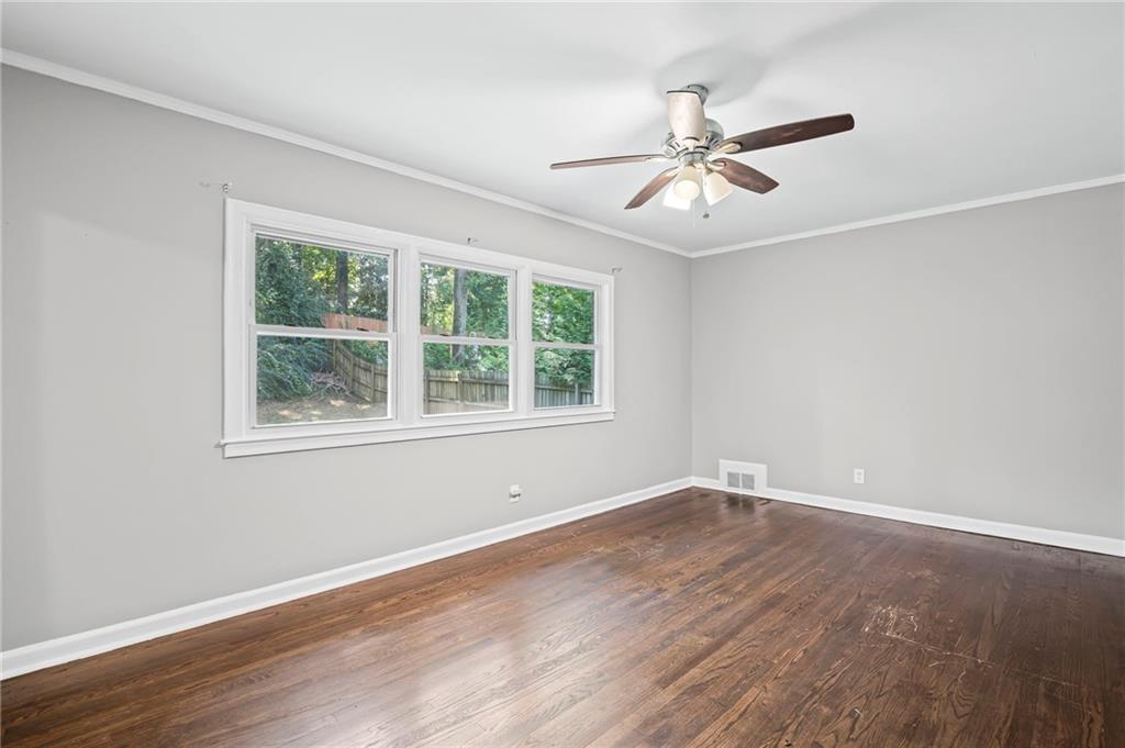 2790 Collier Drive Northwest Atlanta, GA 30318 - Photo 26 of 44 a view of an empty room with wooden floor and a window
