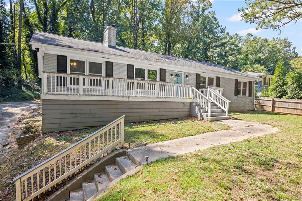 2790 Collier Drive Northwest Atlanta, GA 30318 - Photo 3 of 44 a front view of a house with a yard table and chairs