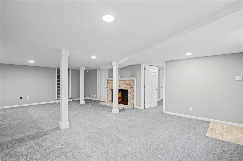 2790 Collier Drive Northwest Atlanta, GA 30318 - Photo 32 of 44 an empty room with fireplace and window