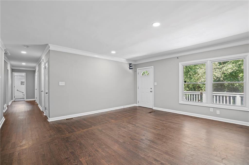 2790 Collier Drive Northwest Atlanta, GA 30318 - Photo 5 of 44 a view of an empty room with wooden floor and a window