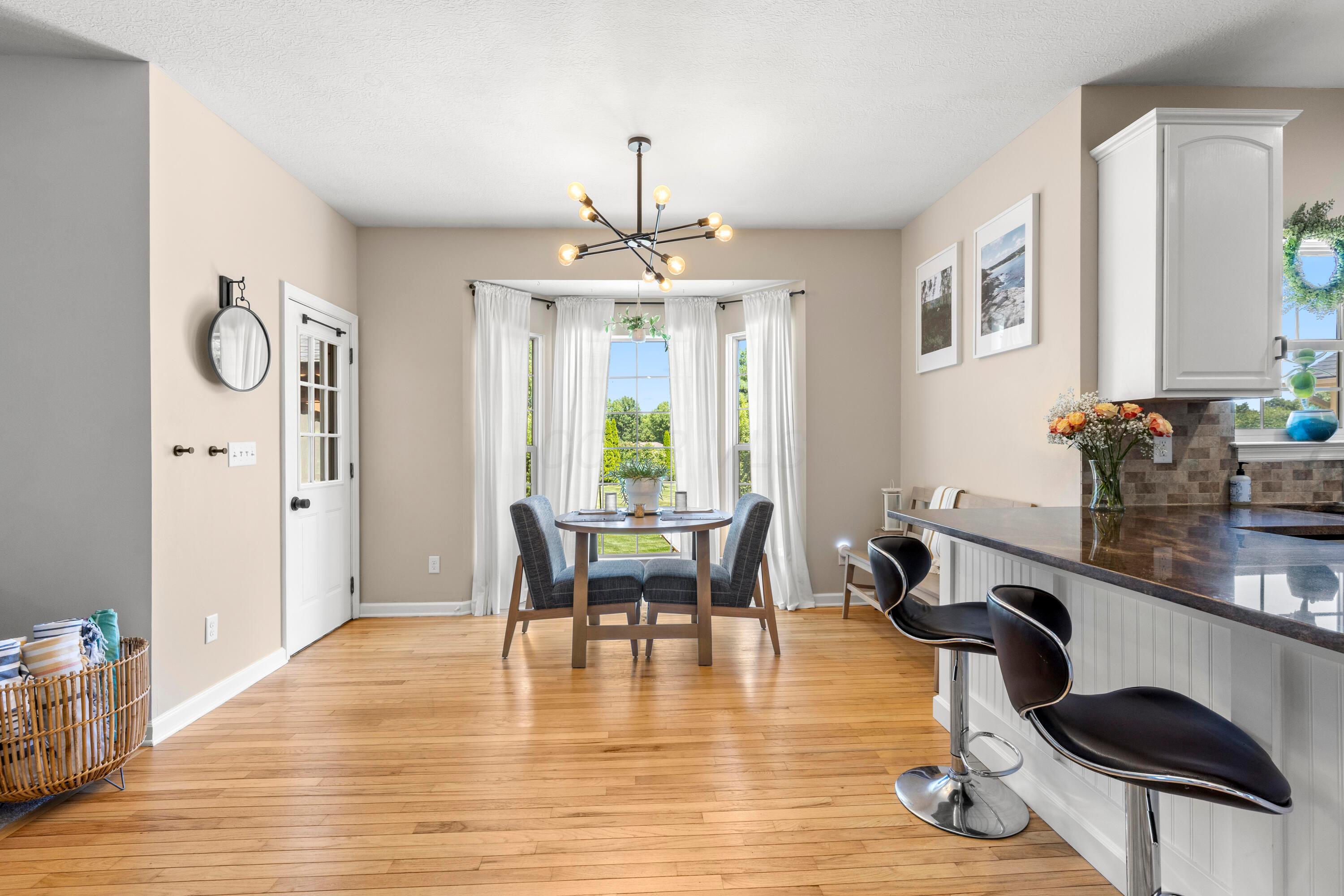 1515 Dale Ford Road Delaware, OH 43015 - Photo 29 of 74 • Hardwood flooring • Ivory painted walls • Coffee bar/planning desk • Chandelier • Bay wall • Mirror is negotiable • Towel hooks remain • Door to deck • Drapes remain